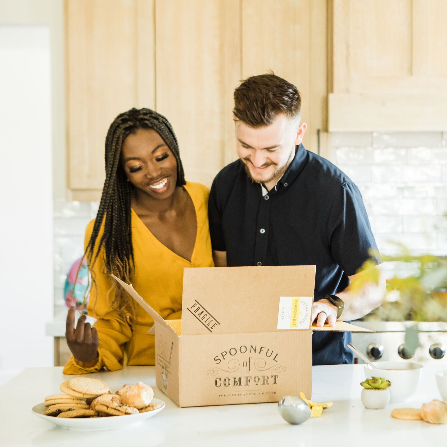 Man and woman opening Spoonful of Comfort soup package.
